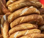 Büyülü Menü Close-up of golden, crispy sesame-coated bread rings, delicious and freshly baked.